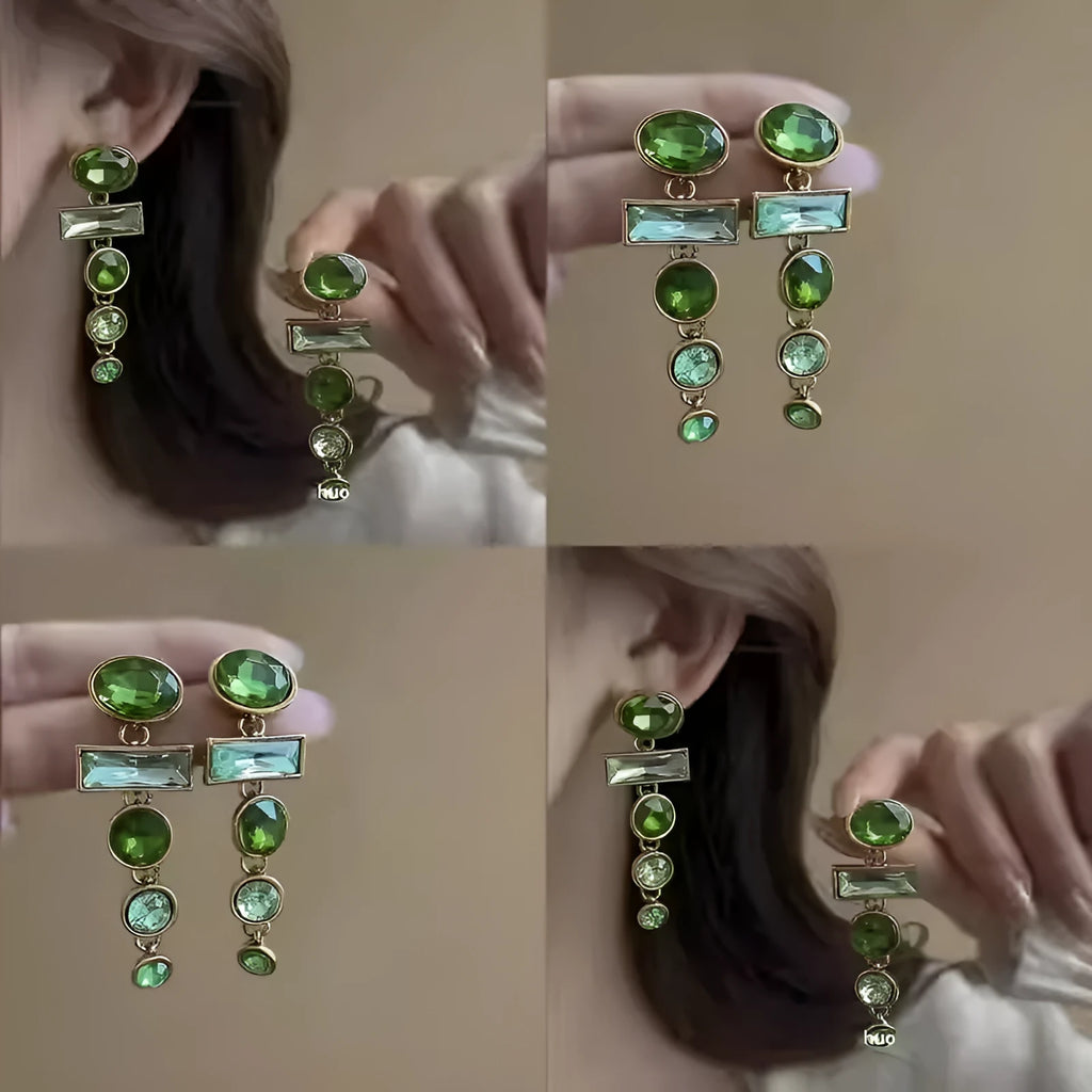 Close-up of green gradient geometric alloy earrings with long tassels and sparkling inlaid zircons.