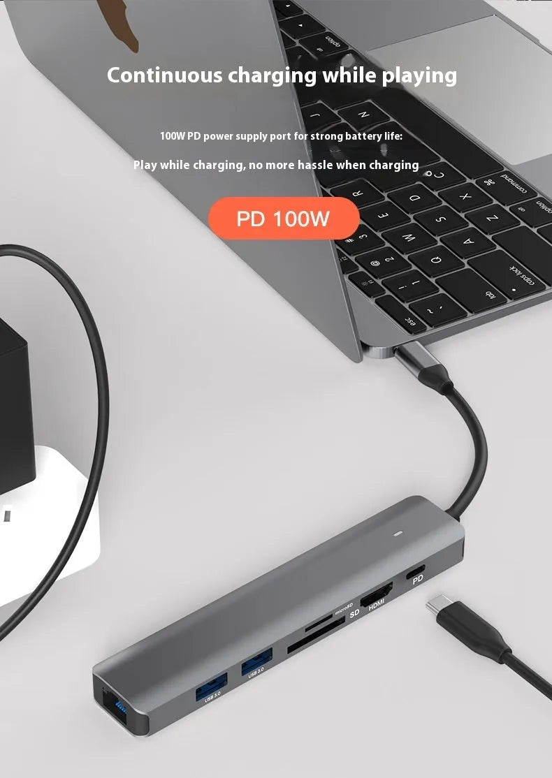 Silver USB C 7-in-1 hub dongle with SD card slot, micro SD slot, and USB C PD charging port.