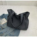 Soft Oxford cloth folding tote bag in a choice of five colours: black, brown, dark grey, light grey, and purple.