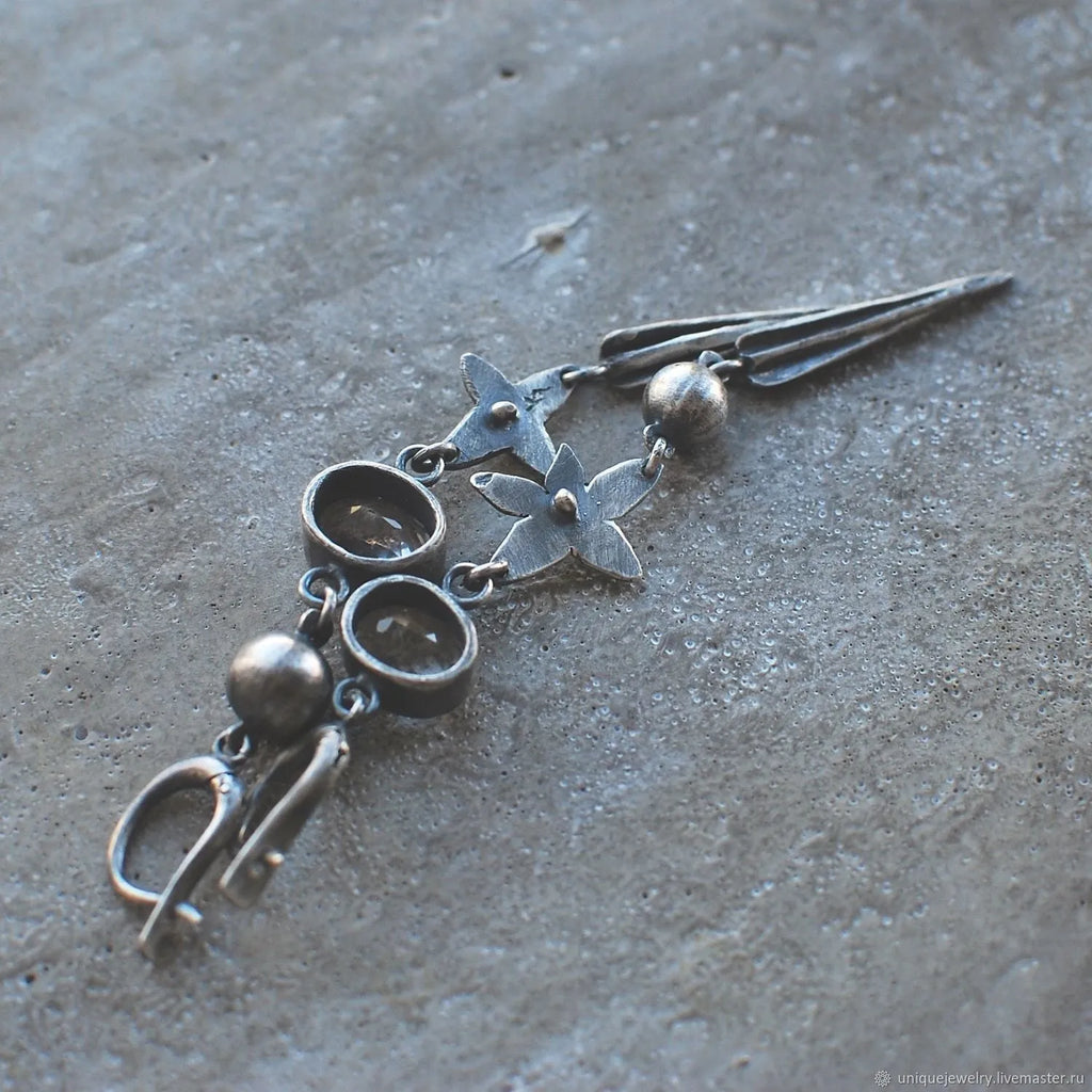 Geometric antique silver earrings with rhinestone accents and XINGX pendant design