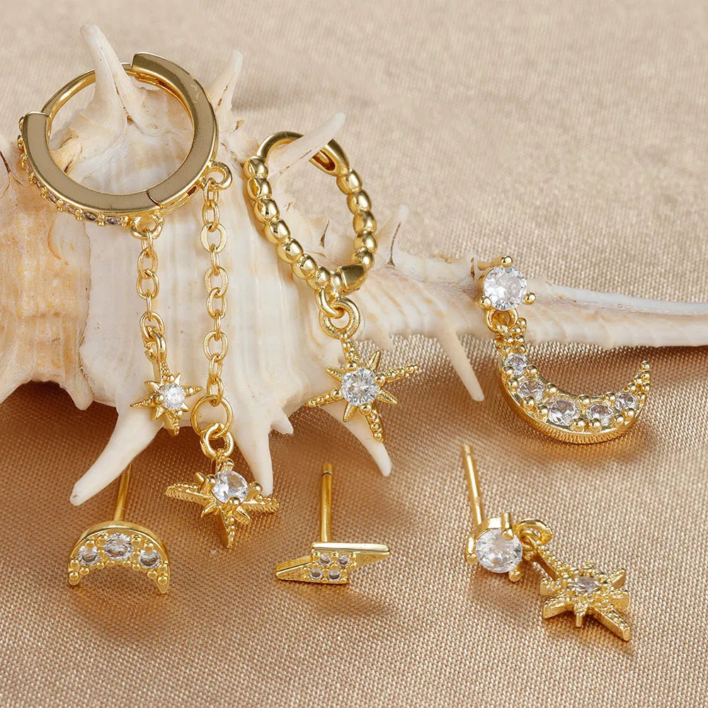 Gold-coloured chain tassel earrings with six dangling elements and zircon stud details on copper construction.