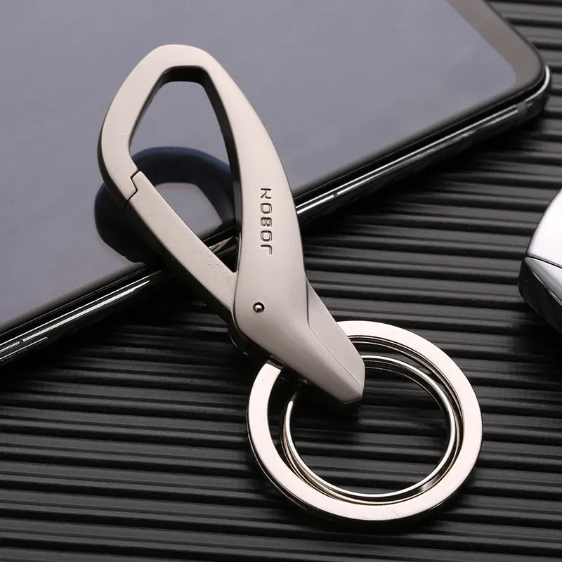 Modern zinc alloy double ring car keychain in black, chrome, and nickel colours showing its 8.3cm by 3.5cm size.