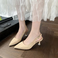 A pair of apricot-coloured suede pointed-toe stiletto high heels with a rubber sole.