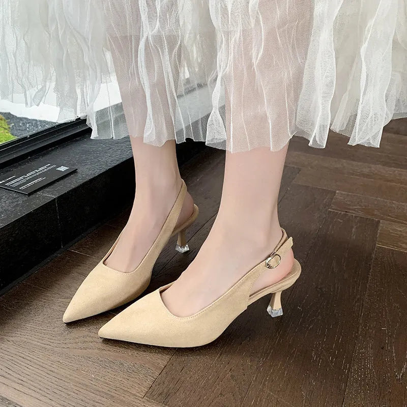 A pair of apricot-coloured suede pointed-toe stiletto high heels with a rubber sole.