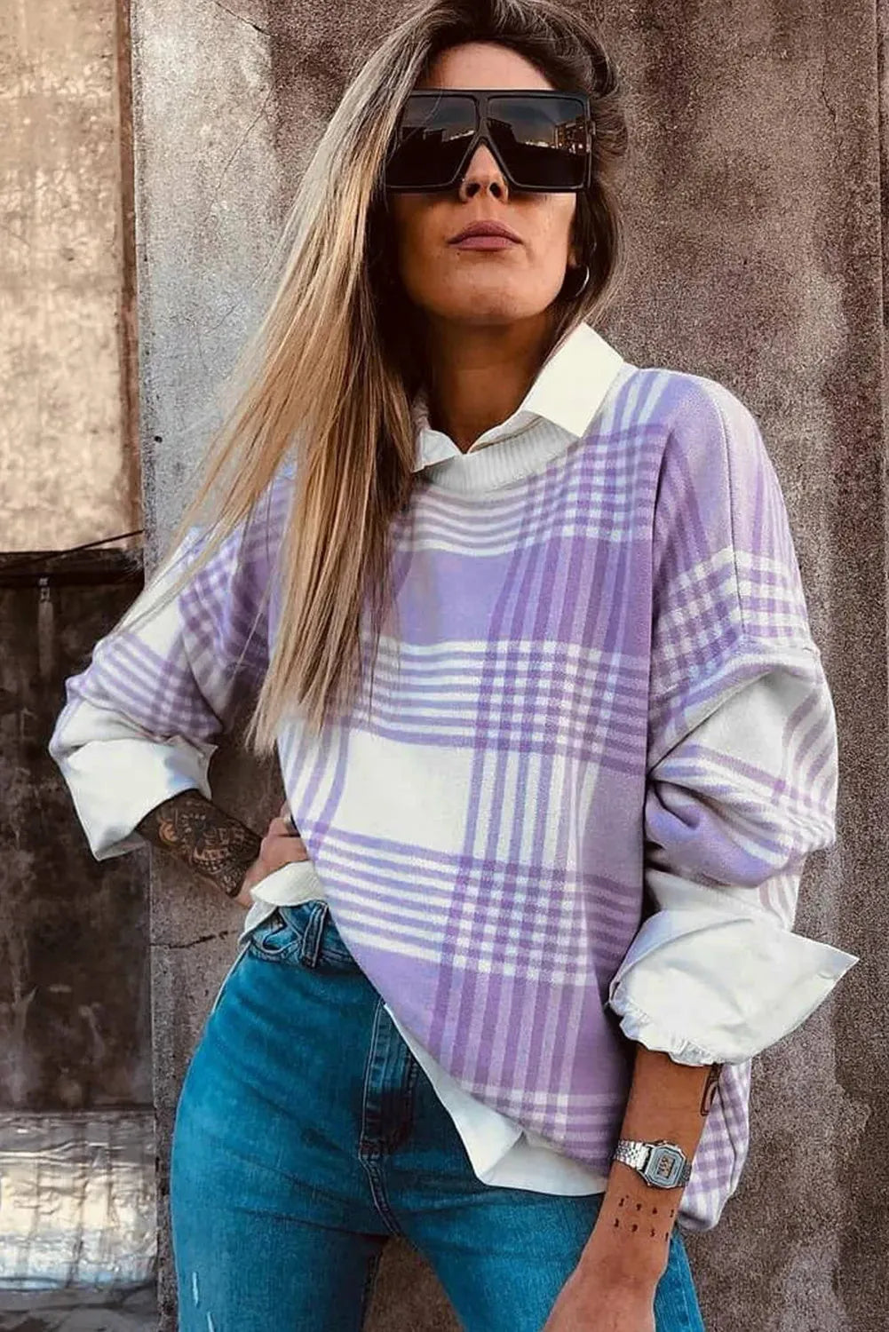 Loose lilac plaid print sweater with ribbed trim on a hanger