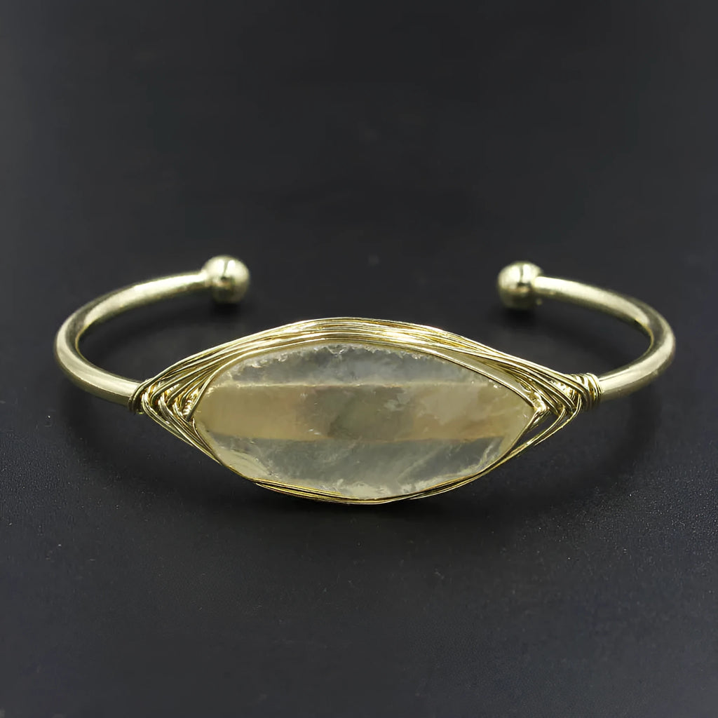 Natural raw gemstone bracelet in amorphous winding shape with simple opening, shown in amethyst crystal colour.