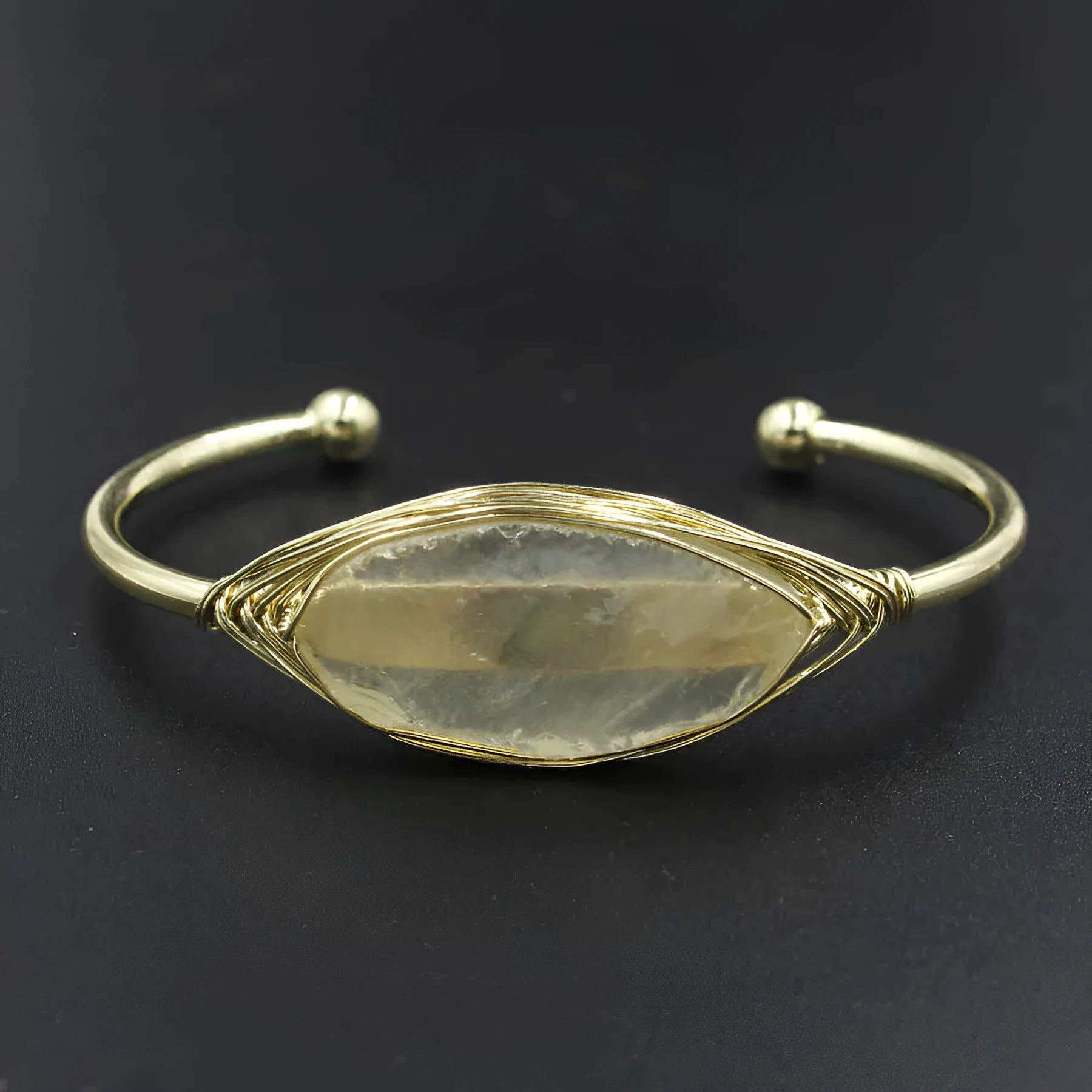 Natural raw gemstone bracelet in amorphous winding shape with simple opening, shown in amethyst crystal colour.