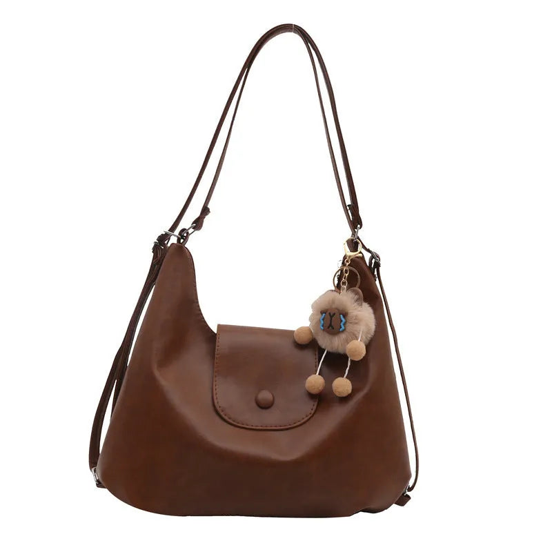 Textured PU leather women's single shoulder bag in horizontal square shape with optional pendant detail