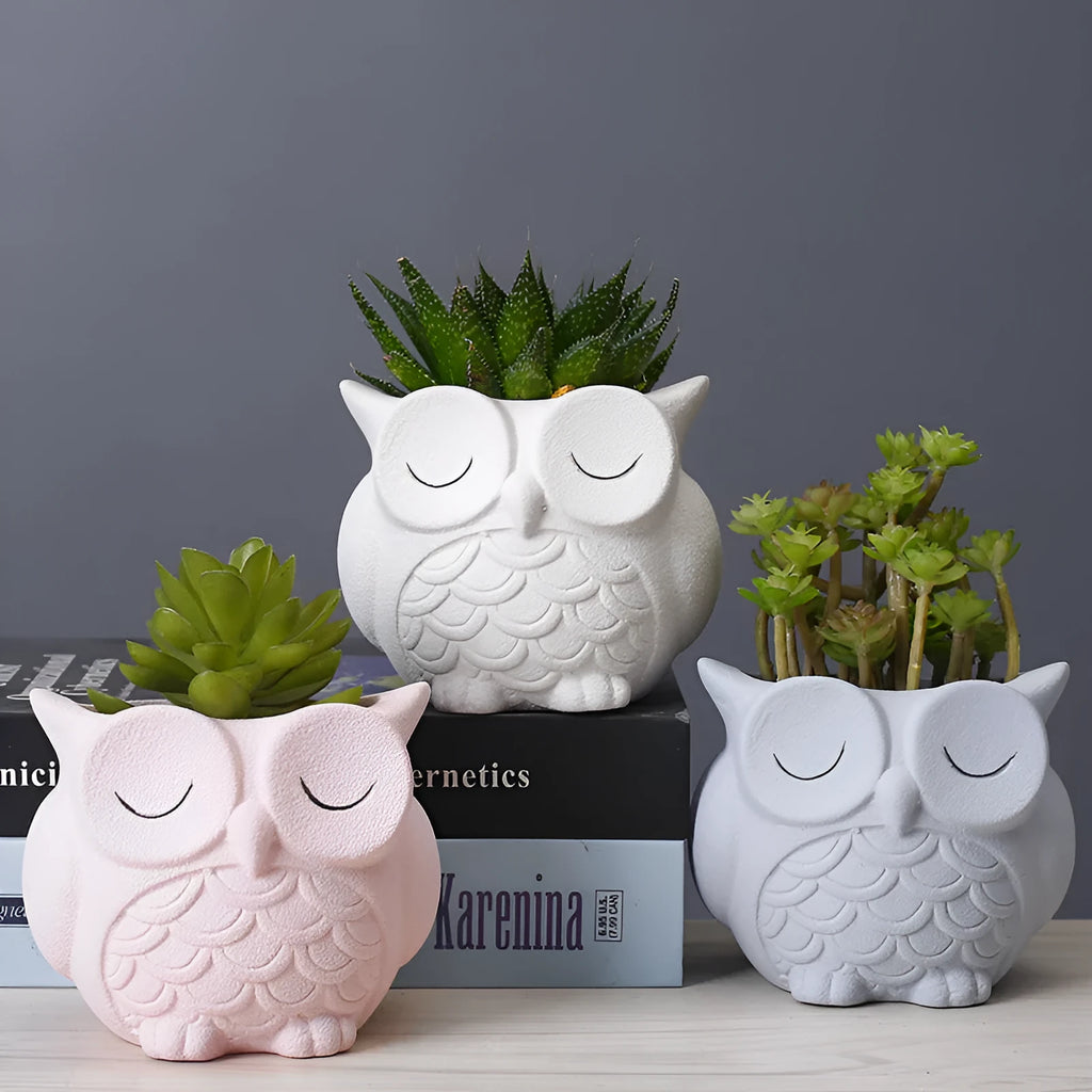 Handmade ceramic owl-shaped succulent plant pot in frosted light pink, shown from the front.