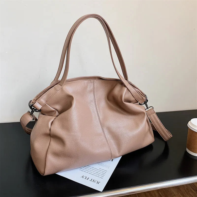 Large soft black PU leather messenger tote bag with a shoulder strap, showing zipper and phone pocket.