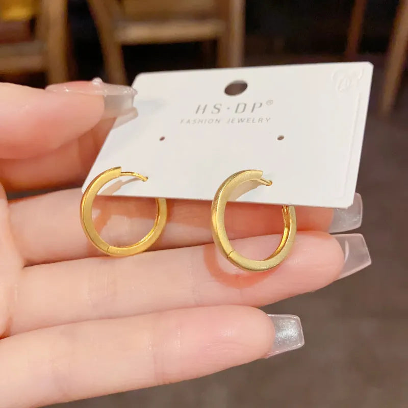 Geometric circular ear clips with gold plating in gold and silver colour options