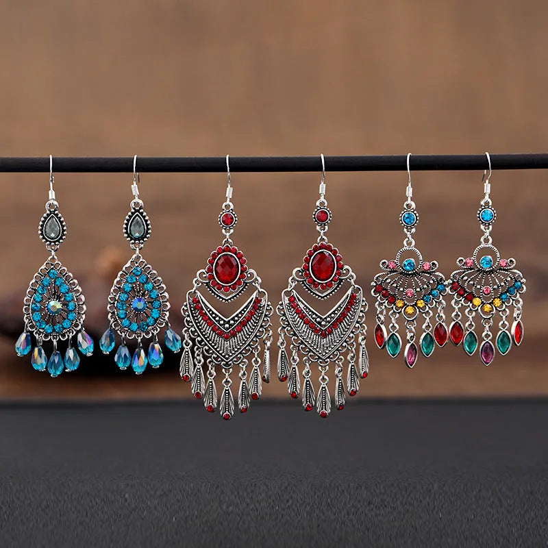 Pair of long purple drop shape fringe earrings with crystals in a retro ethnic style.