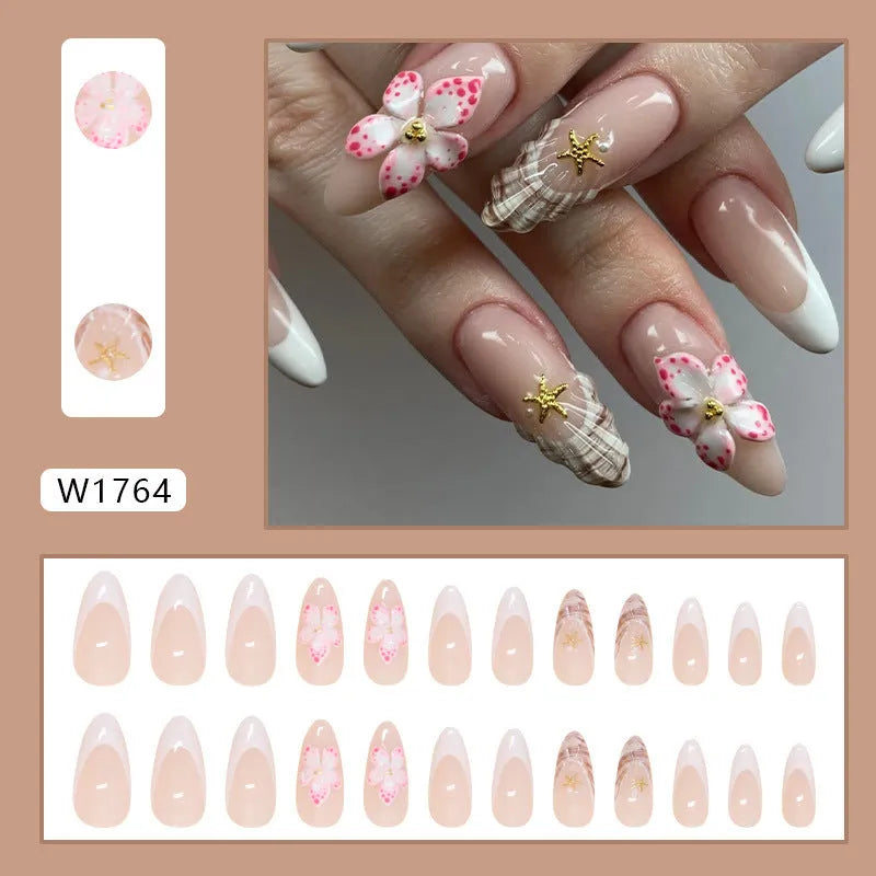 French style false nails with simple white flower and rock pattern design on a pink background, colour W1764.