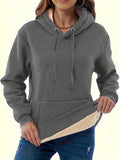 A woman's loose-fit hooded sweater with a raised 3D pattern, shown in a wine red colour.
