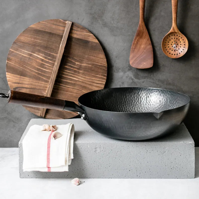 Black traditional iron wok with wooden handle measuring 40cm diameter