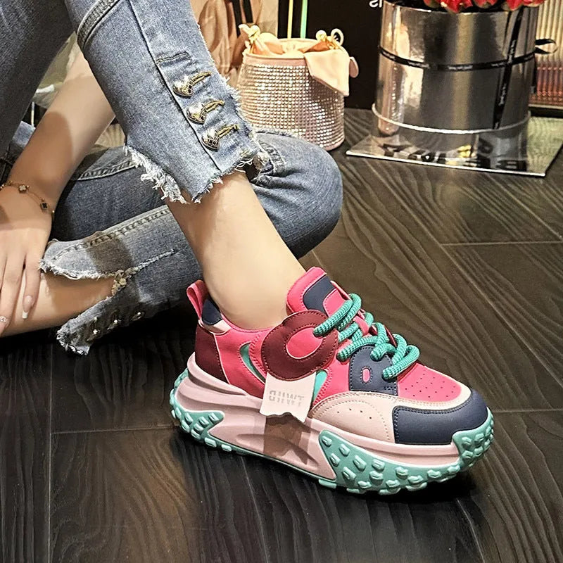 Pair of thick-soled leather sports casual shoes with wedge heels and front lace-up fastening.