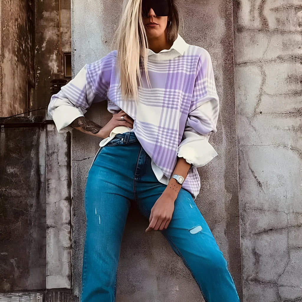 Loose lilac plaid print sweater with ribbed trim on a hanger