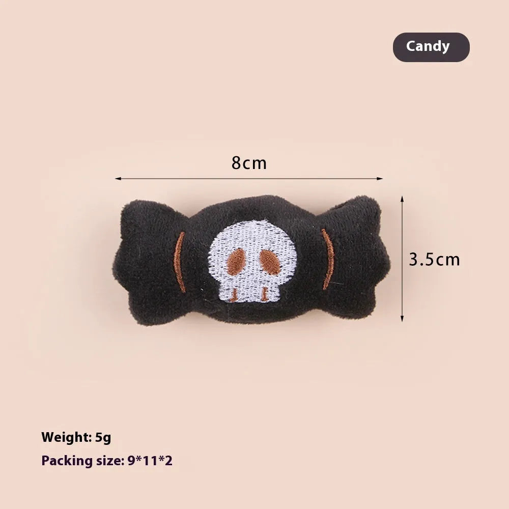 Small plush cat teaser wand with three interchangeable attachments: candy, eyes and skull designs