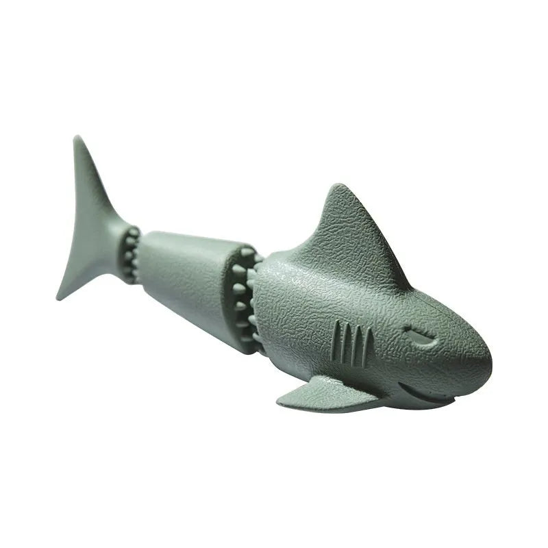 Blue and green rubber dog toys shaped as a shark, a conch, and a starfish on a white background.