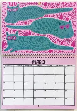 Cat themed wall calendar planner with daily tear-off sheets, showing photographic cat portraits and a clear date grid.
