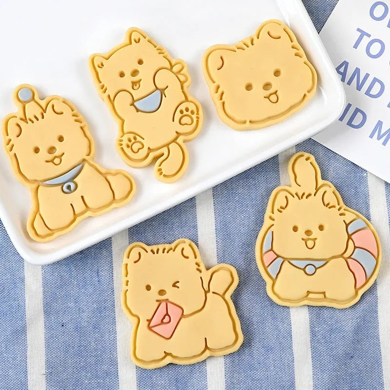 Three dimensional plastic biscuit mold with puppy cartoon designs including puppy head and birthday hat