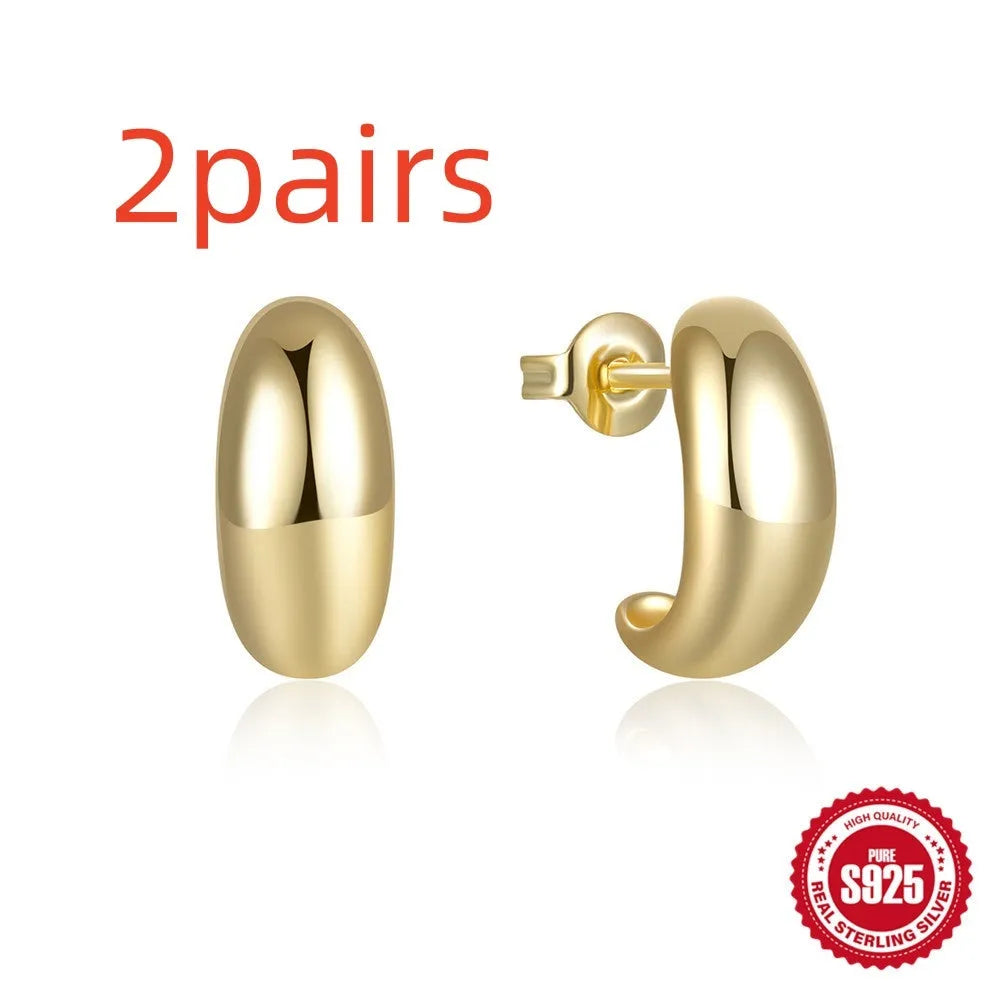 Sterling silver C-shaped stud earrings in electroplated gold or white gold finish