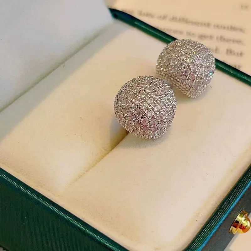 Golden beans drop-shaped earrings with full diamond embellishment and geometric design