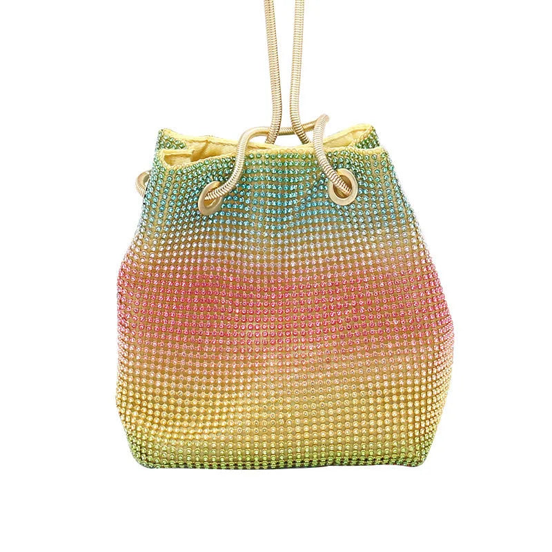 Rainbow coloured rhinestone bucket bag with a crossbody shoulder strap on a white background.