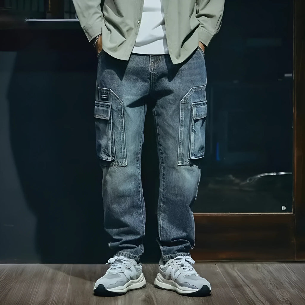 Men's blue loose straight-leg stretch denim casual trousers on a plain background