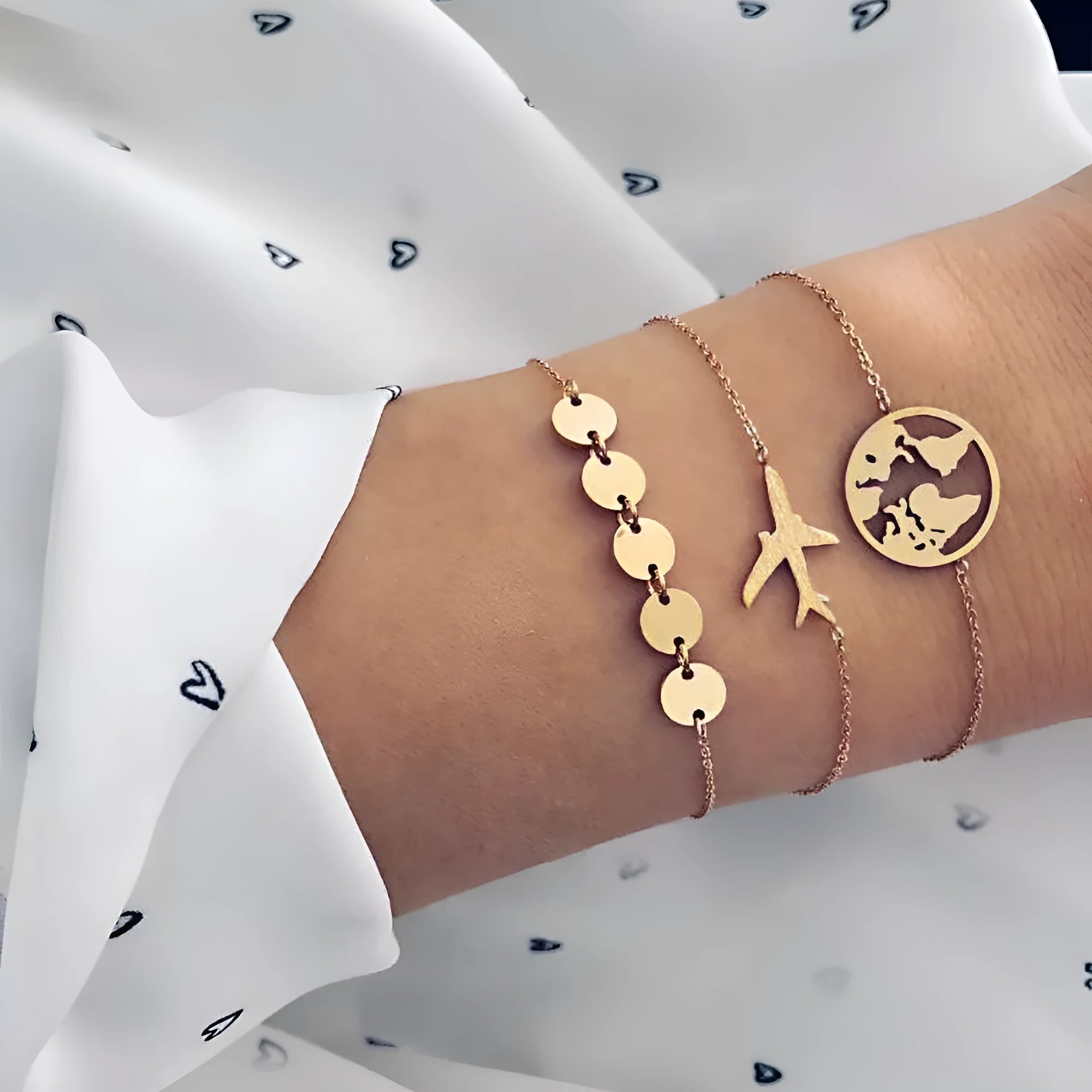 Three bohemian bracelets with heart-shaped aircraft map charms in silver tone