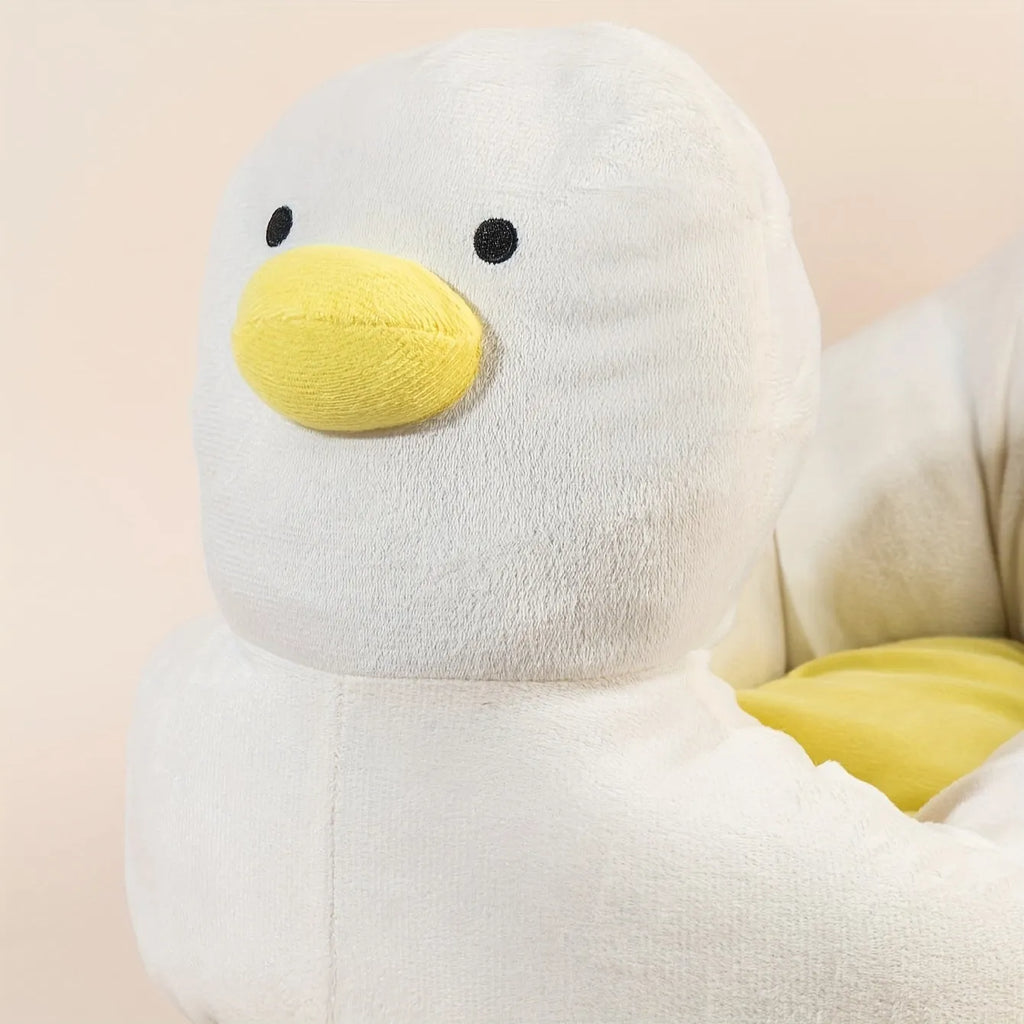 Blue duck-shaped fluffy pet bed for a small dog on a wooden floor.