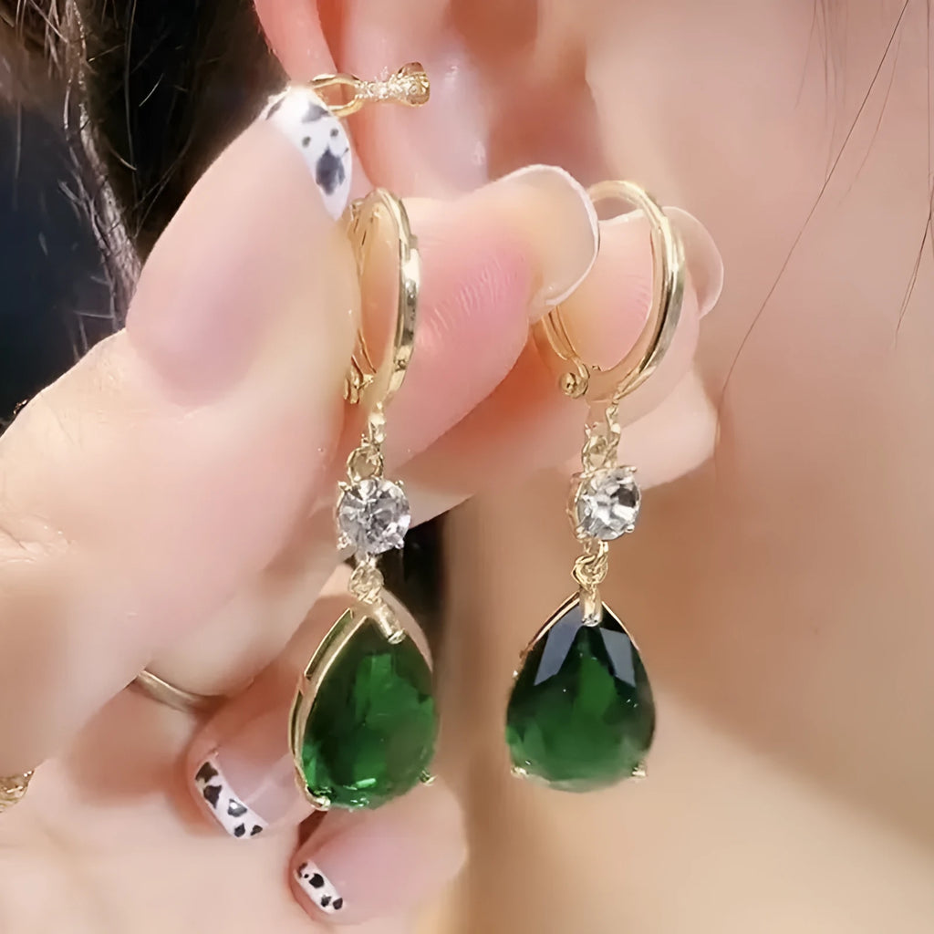 Emerald green geometric teardrop alloy earrings dangling from a model's ear.