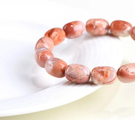 Natural cherry agate barrel bead bracelet with Ruyi pattern measuring 10x14mm