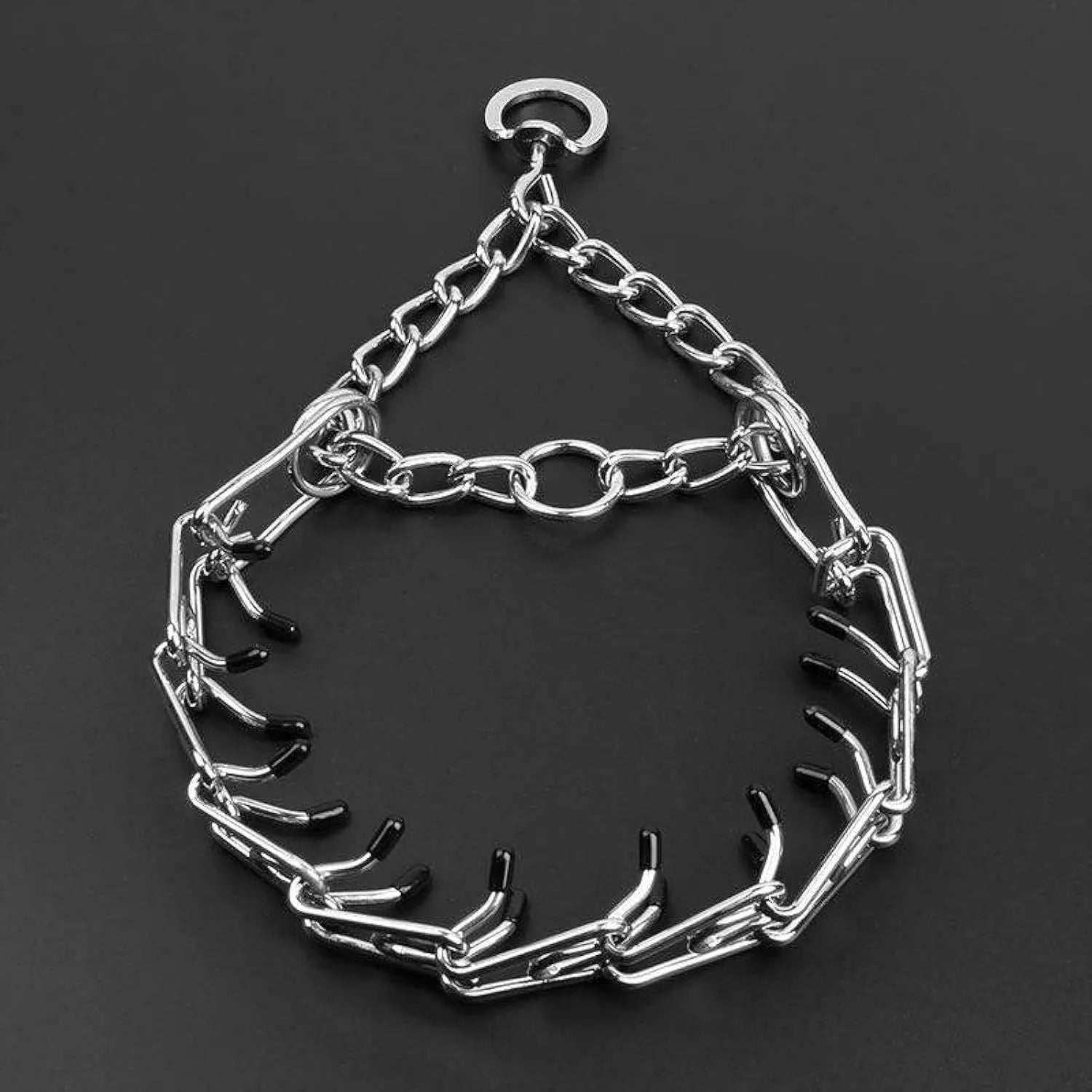 Stainless steel adjustable dog prong training collar with comfort rubber tips on a grey background