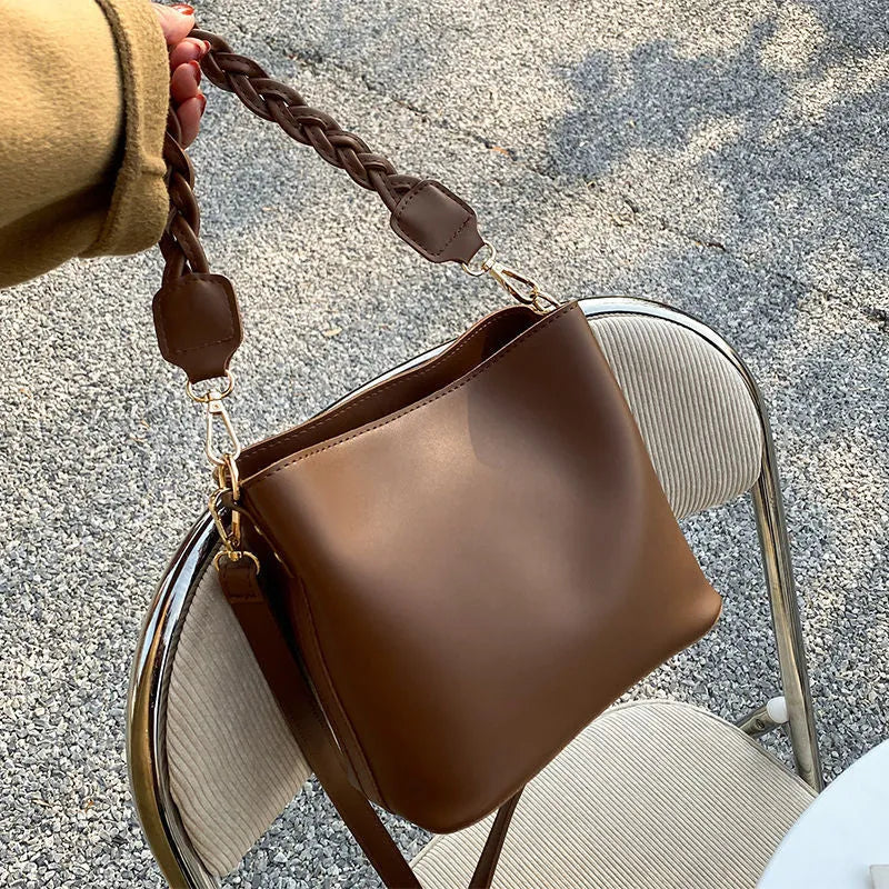 Retro woven PU leather crossbody bucket bag in khaki colour showing bucket shape and shoulder strap