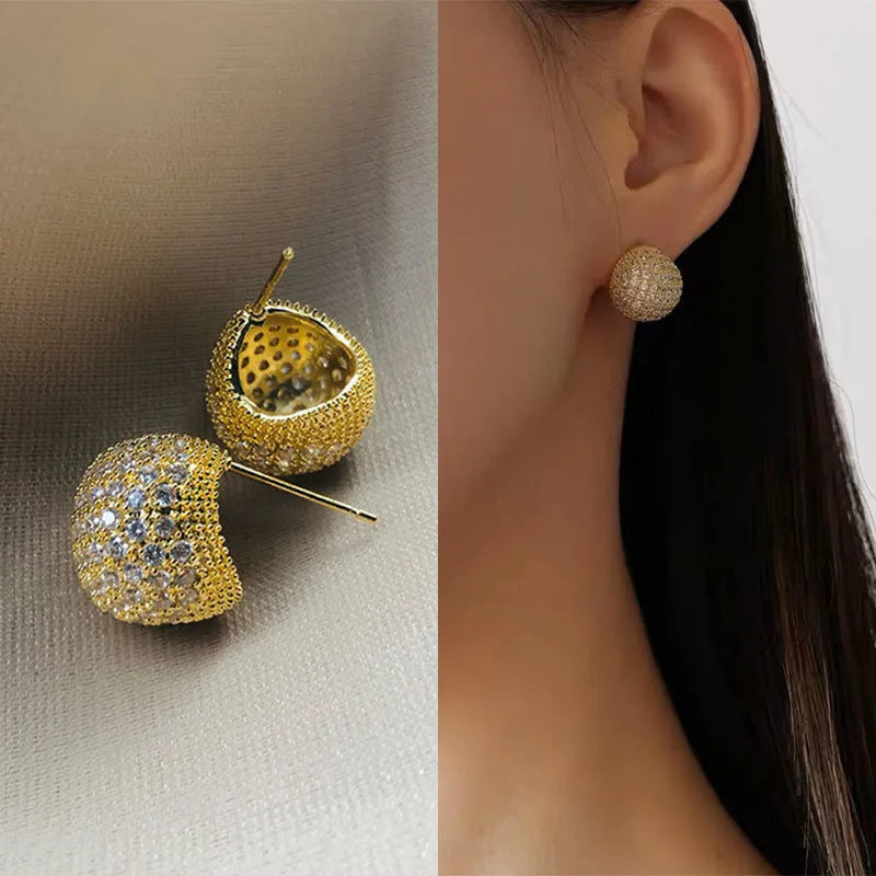 Golden beans drop-shaped earrings with full diamond embellishment and geometric design