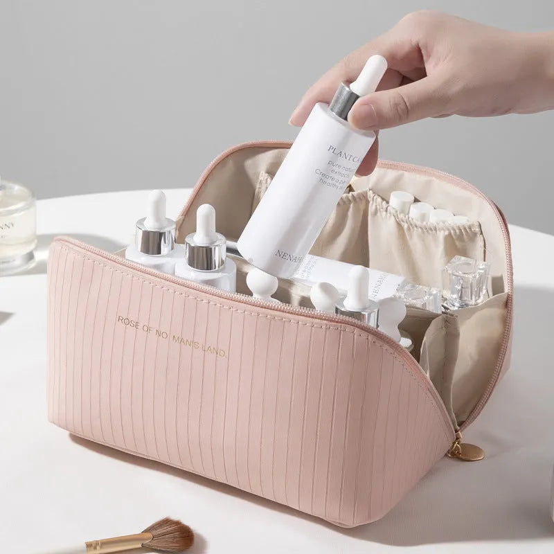 Cubic pillow-shaped PU makeup bag in a vertical pattern, shown in one of five colours: beige, black, brown, grey, or pink.