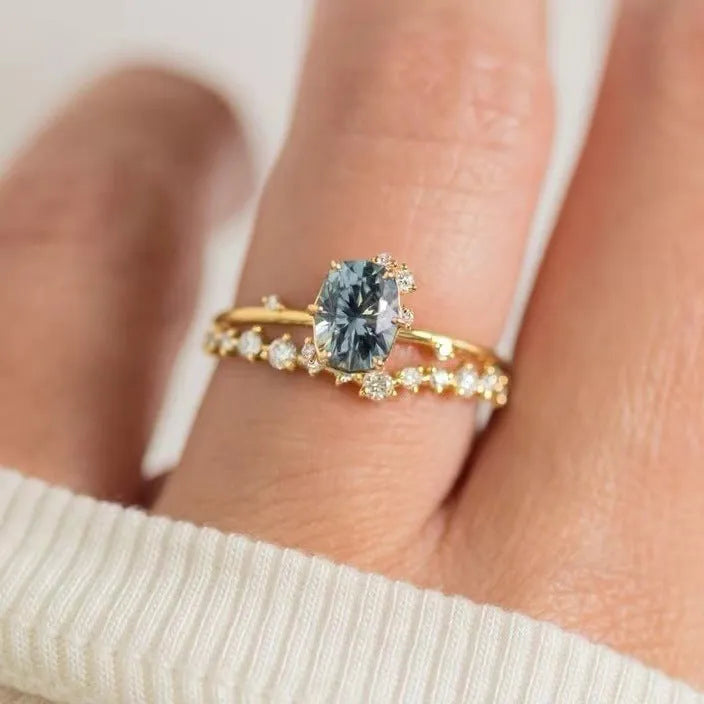 Gold plated women's flower ring with a green zircon stone, shown in sizes 6 to 10.
