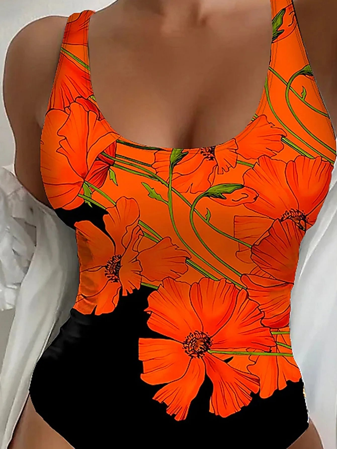 Orange flowers printed backless one-piece swimsuit laid flat, showing slim fit and polyester fabric.
