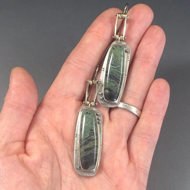Pair of two-colour marble pattern geometric alloy earrings on simple background