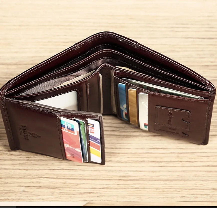 Men's black leather wallet open to show internal card slots, coin pocket, and document sleeve.