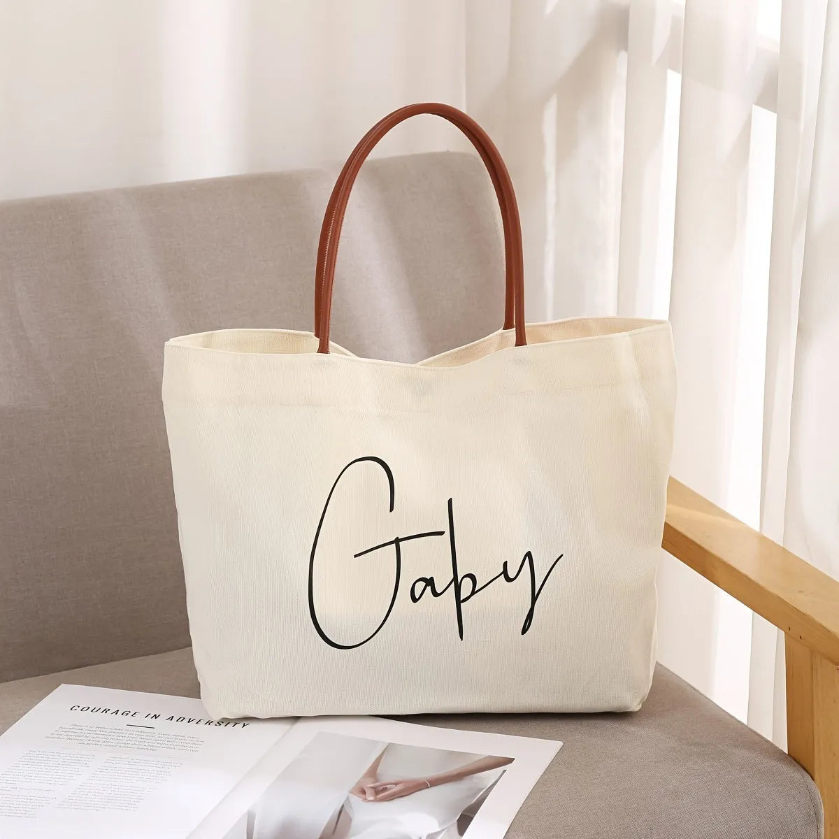 Beige white cotton canvas tote bag with sturdy handles on a plain background.
