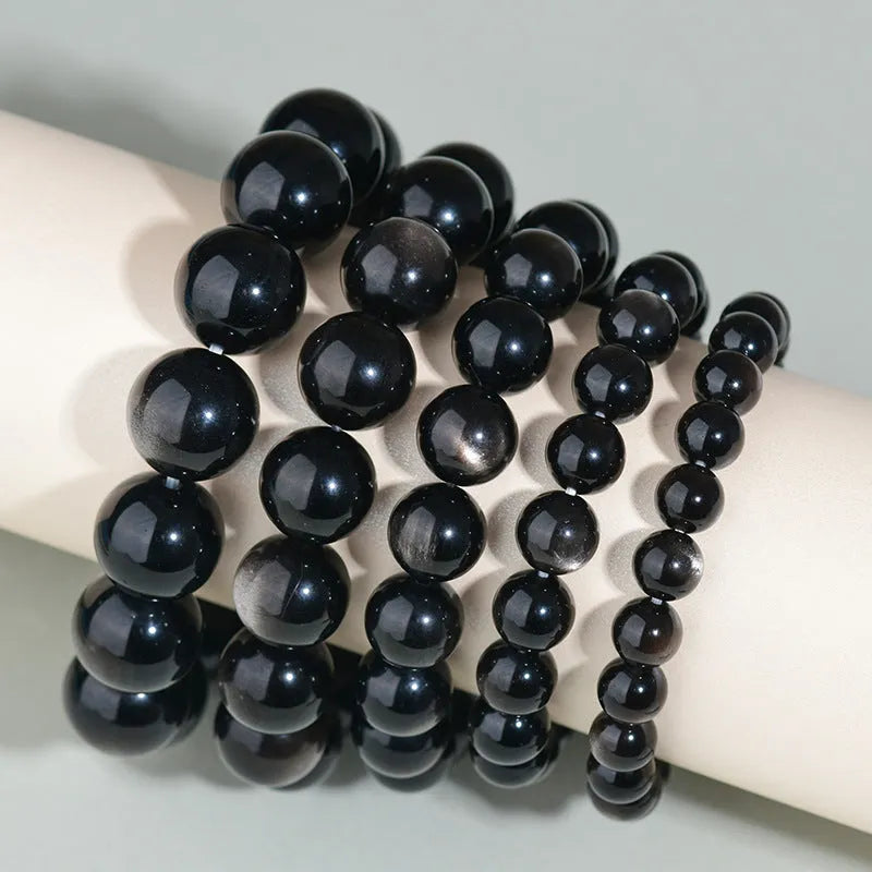 Hand-woven obsidian couple bracelets showing six crystal colour variations with round beads in ethnic style design