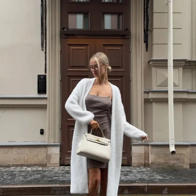 White knitted cardigan jacket with long sleeves and loose fit, shown as a versatile women's outerwear garment