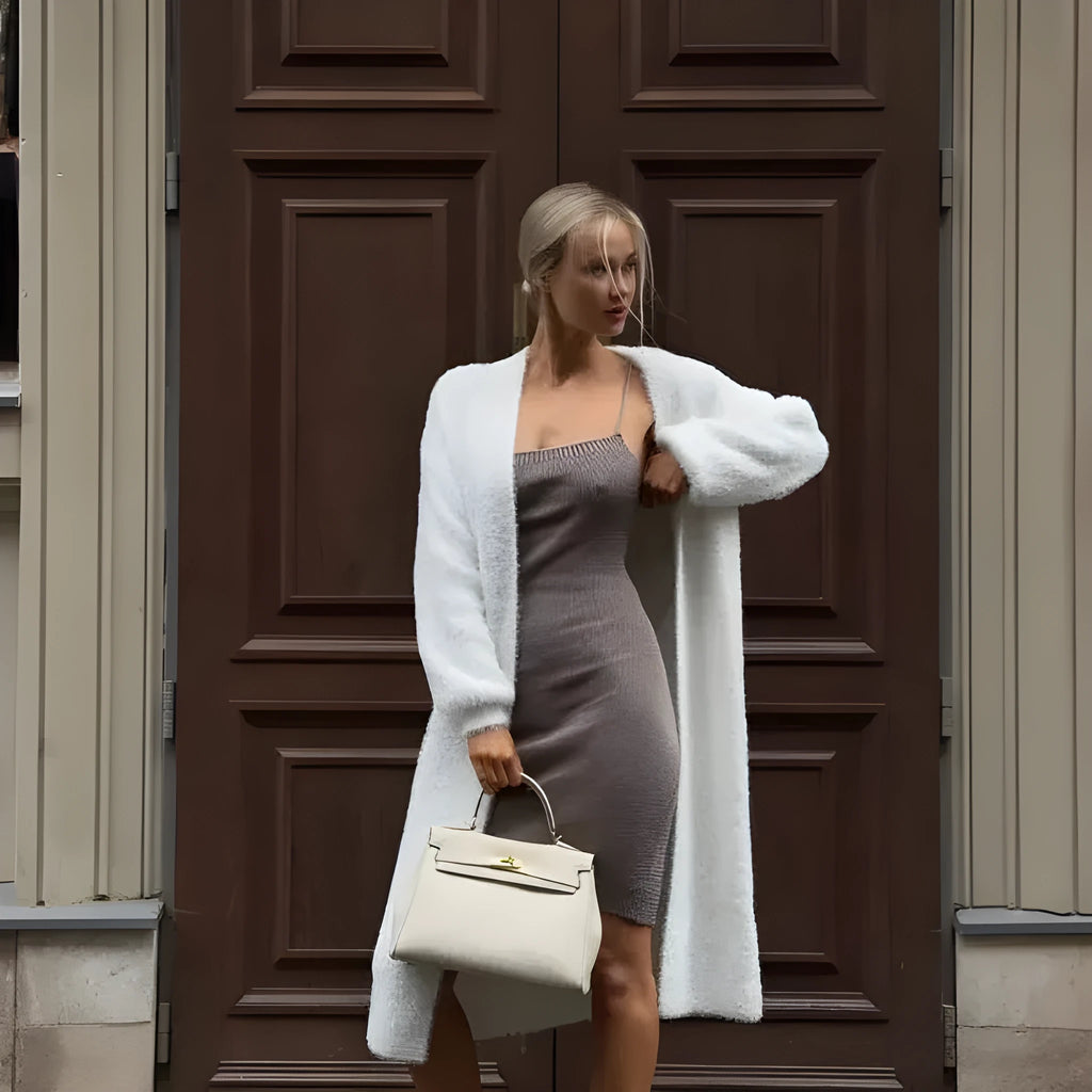 White knitted cardigan jacket with long sleeves and loose fit, shown as a versatile women's outerwear garment