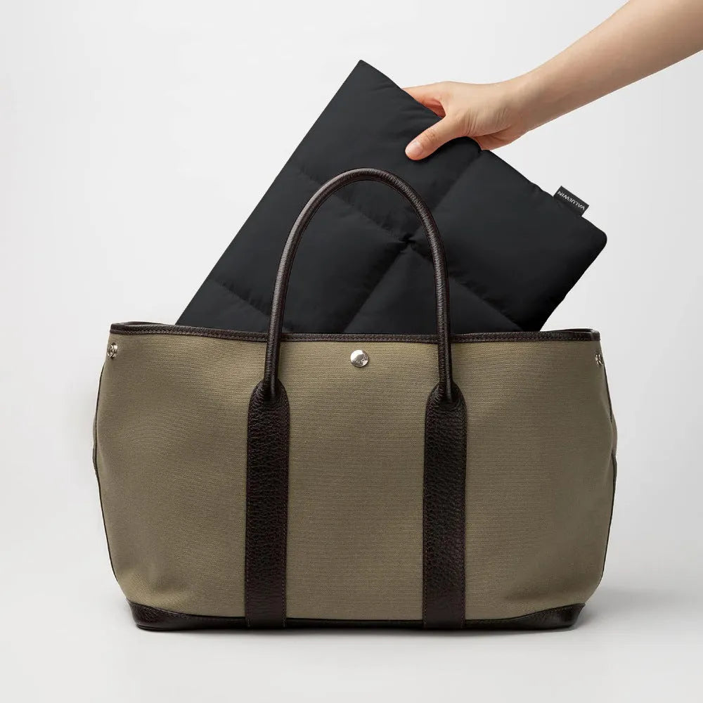 Black polyester laptop sleeve showing sewing thread detailing and soft texture for 13-15.6 inch laptops