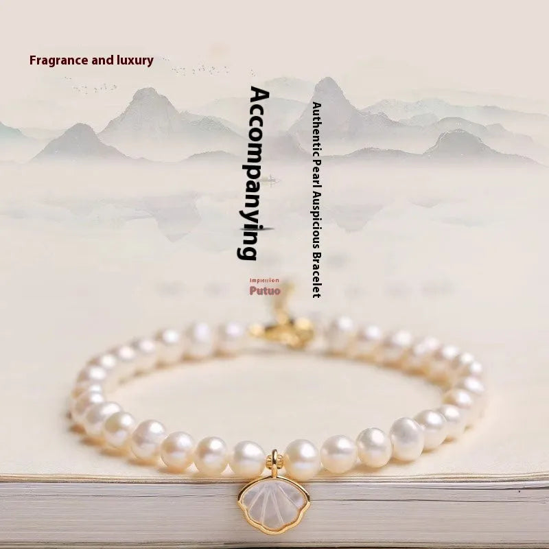Women's freshwater pearl bracelet with fan-shaped arrangement of 5-6 near round pearls on 16cm band