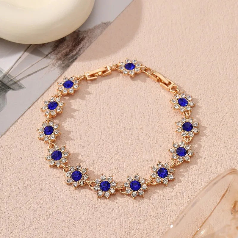 Gold and silver tone zinc alloy flower bracelet with electroplated coloured gemstones including crystal and diamond accents.