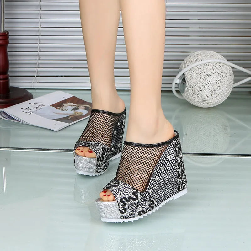 Women's black mesh flip flops with a chunky platform sole featuring a hollowed-out heel design.