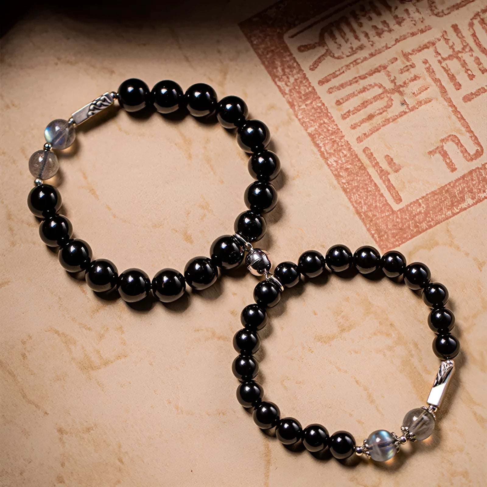 Obsidian Buddha beads couple bracelet DIY kit showing 8mm and 10mm beads with stringing materials